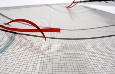 A close up of a wire mesh with red lines