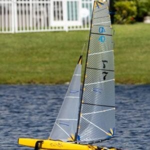 A yellow sailboat is in the water.